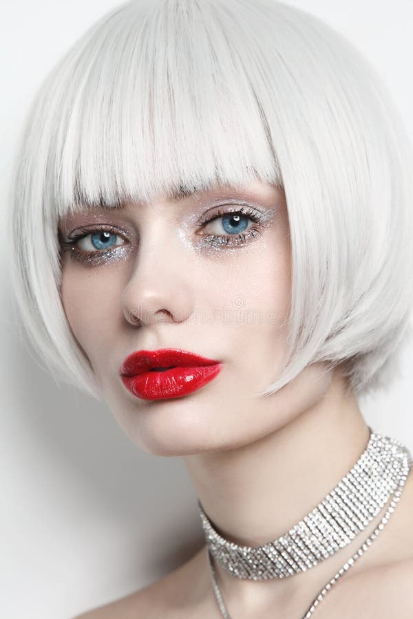 Vintage style portrait of young beautiful woman with platinum blonde hair and red lips. Vintage style portrait of young beautiful woman with platinum blonde hair and red lips