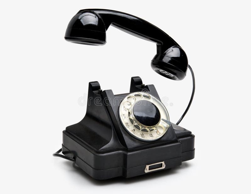 Old black vintage rotary style telephone isolated over a white background. Old black vintage rotary style telephone isolated over a white background