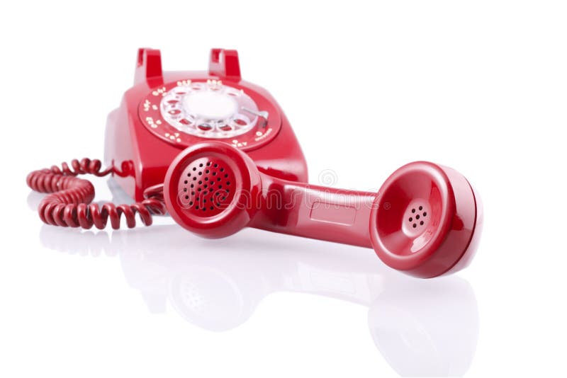 A red vintage 1950-s Western Electric 500 model rotary telephone isolated on white a clipping path. A red vintage 1950-s Western Electric 500 model rotary telephone isolated on white a clipping path.