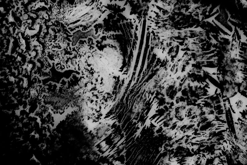Weird abstract backlit ice patterns on frozen glass with bizarre lines, curves, cracks, spots. bnw texture wallpaper stock images Weird abstract backlit ice patterns on frozen glass with bizarre lines, curves, cracks, spots. bnw texture wallpaper stock images