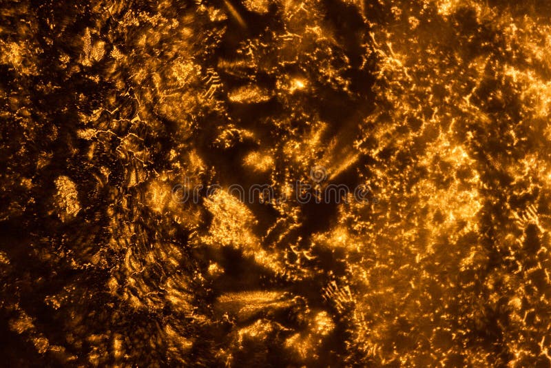 Weird abstract backlit ice patterns on frozen glass with bizarre lines, curves, cracks, spots. orange texture wallpaper royalty free stock photos Weird abstract backlit ice patterns on frozen glass with bizarre lines, curves, cracks, spots. orange texture wallpaper royalty free stock photos