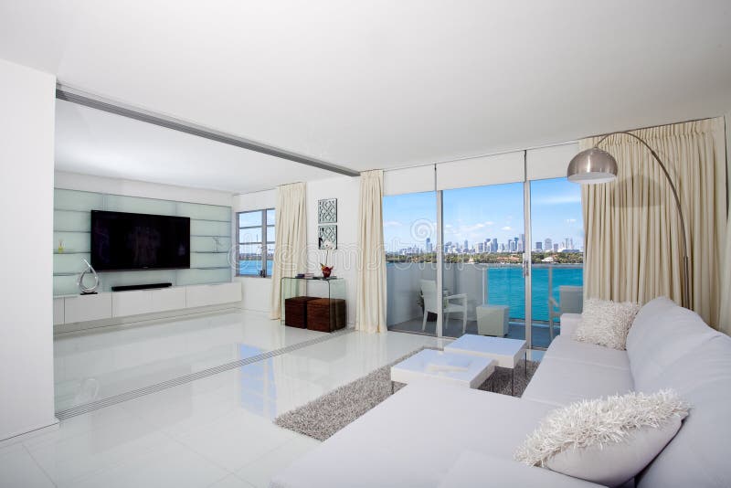 White interior of a condo with sliding pocket doors overlooking South Beach in Miami. White interior of a condo with sliding pocket doors overlooking South Beach in Miami.