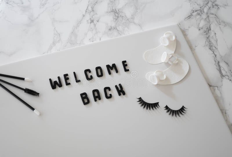 Welcome Back beauty business sign in black and white against marble backdrop. Monochrome beauty background concept set against a white marble backdrop. Lash royalty free stock photos Welcome Back beauty business sign in black and white against marble backdrop. Monochrome beauty background concept set against a white marble backdrop. Lash royalty free stock photos