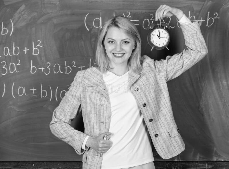 Welcome teacher school year. Looking committed teacher complement qualified workforce educators. School discipline. Concept. Woman teacher hold alarm clock. She stock photography Welcome teacher school year. Looking committed teacher complement qualified workforce educators. School discipline. Concept. Woman teacher hold alarm clock. She stock photography