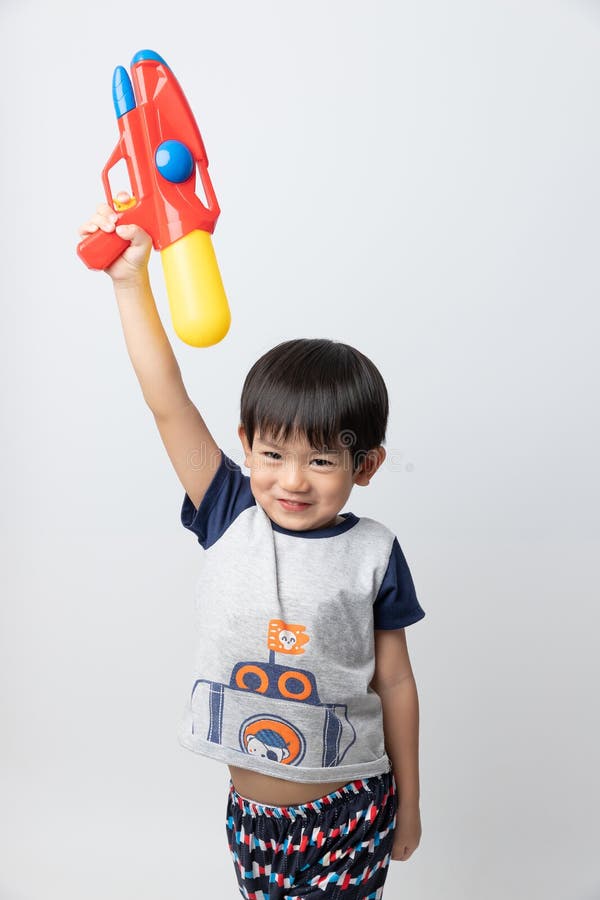 Welcome Thailand Songkran festival, Portrait of Asian boy smiled with water gun on white background royalty free stock photography Welcome Thailand Songkran festival, Portrait of Asian boy smiled with water gun on white background royalty free stock photography