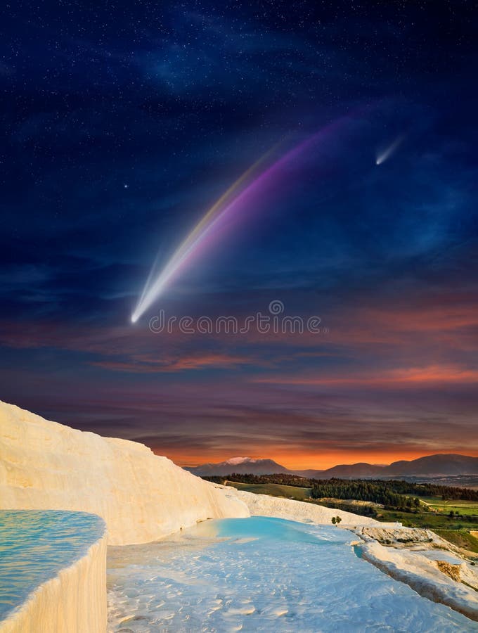 Fantastic unreal image: giant colorful comet in dark starry sky over white Pamukkale, Turkey royalty free stock image
