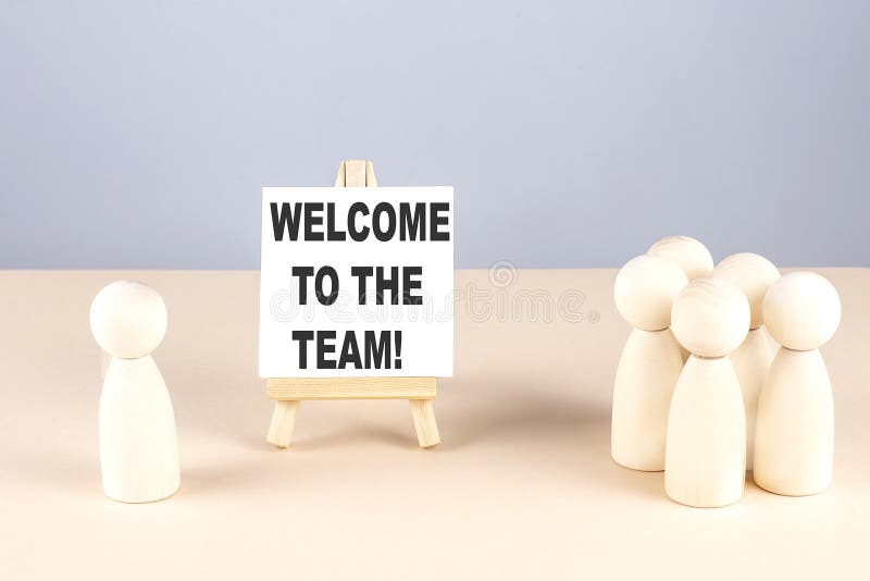 WELCOME TO TEAM text on easel with wooden figure, meeting concept