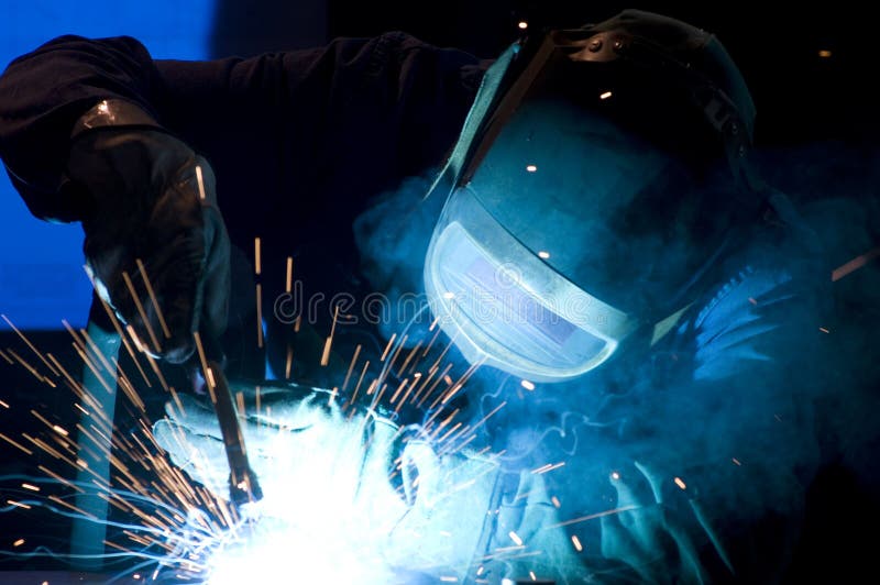 L'uomo al lavoro saldatore con scintilla di un arco.