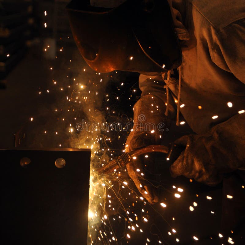 Welder assembling technical steel. Industrial welding of metal structures royalty free stock photos
