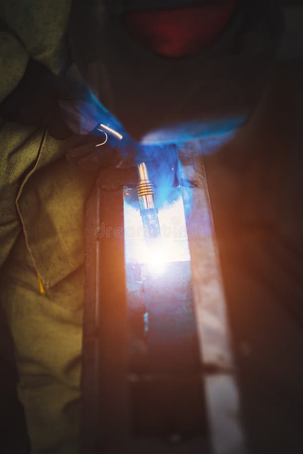 Welder weld inside metal beam stock photos