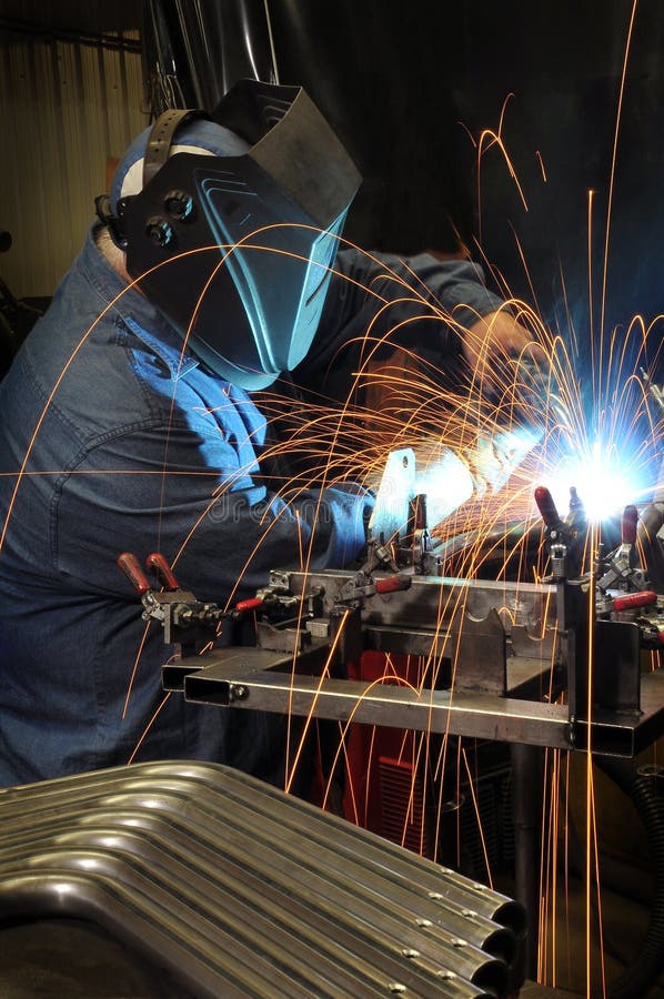 Welder welding in an industrial factory