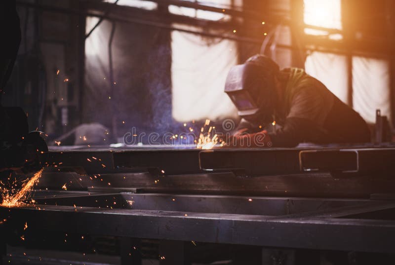 A Welder with a Welding Machine Works in a Factory Stock Photo Image of factory, industry