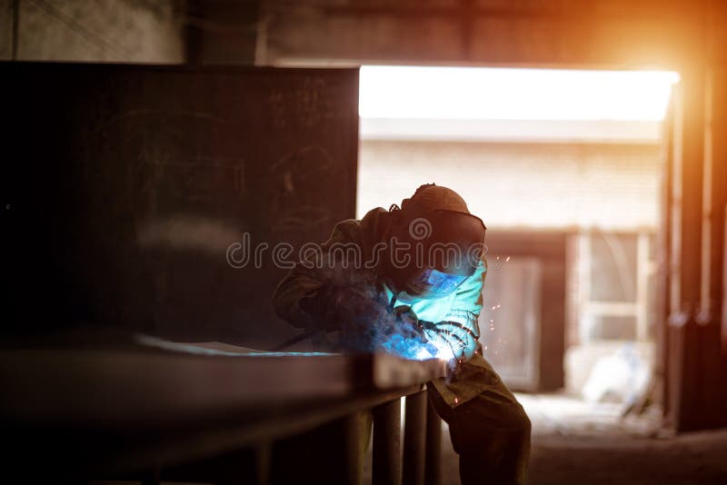 A Welder with a Welding Machine Works in a Factory Stock Image Image of labor, iron 207709345