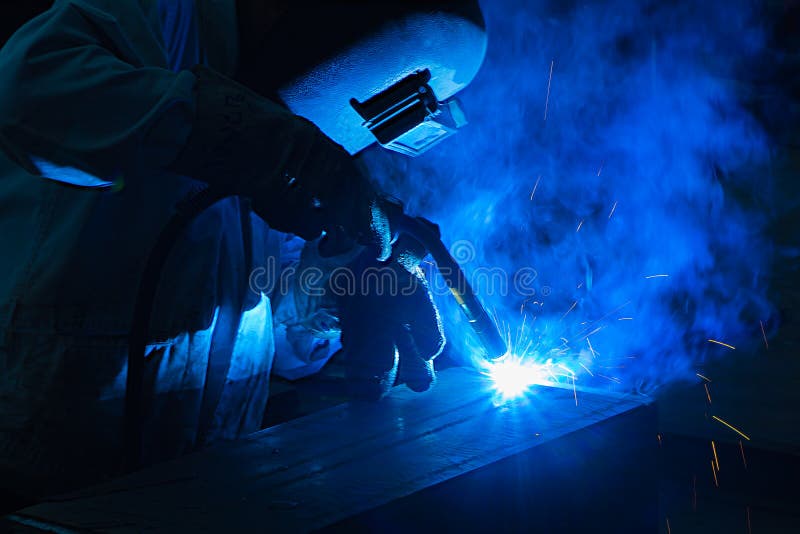 Welder Welding Angle Iron with Stick Electrode with Red and Blue