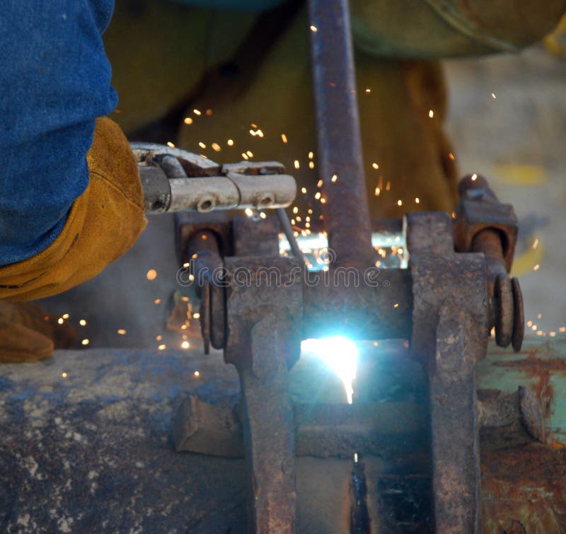 Welding two pipes together stock photo. Image of blue 7520376