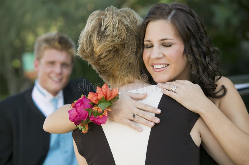 Well-dressed teenagers hugging