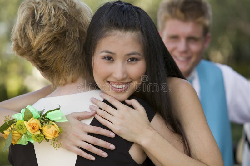 Well-dressed teenagers hugging