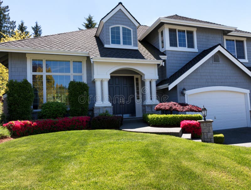 Well maintain front lawn of clean home during spring season royalty free stock photo