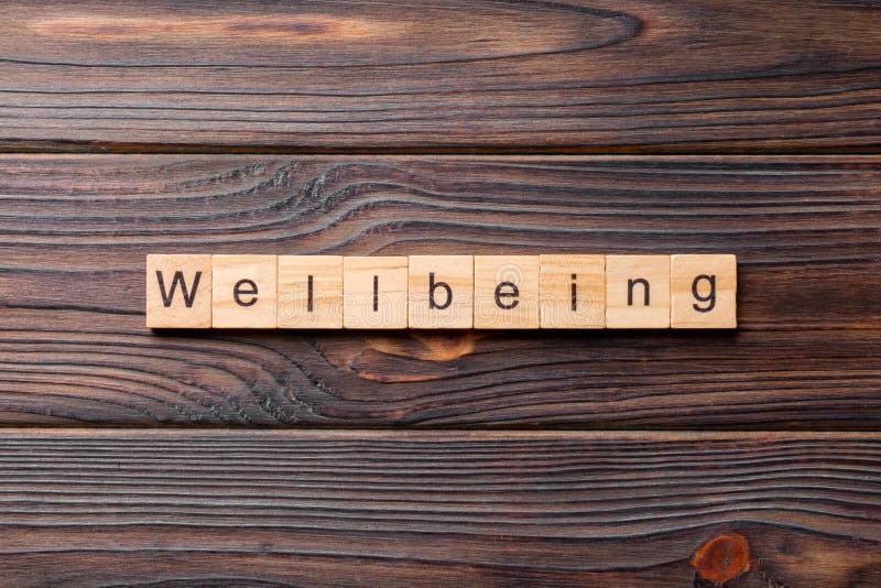 Wellbeing word written on wood block. Wellbeing text on cement table for your desing, concept