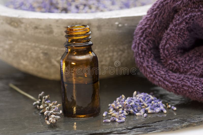 Wellness care products lavender oil and a towel royalty free stock photography Wellness care products lavender oil and a towel royalty free stock photography