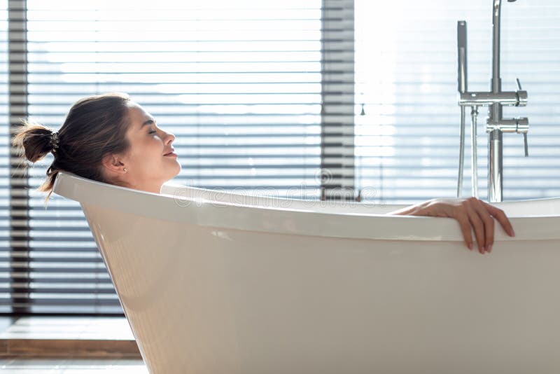 Wellness Concept. Beautiful Young Female Relaxing In Bathtub In Modern Bathroom