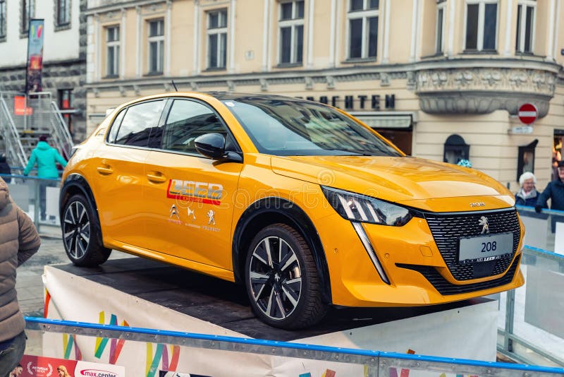 Wels, Austria - January 11th,2020: Newest Peugeot 208 gt-line 2020 model stand on basement among public skating rink in