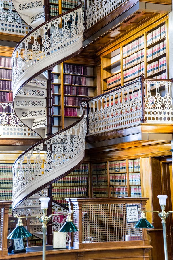 Law Library Inside the Des Moines Iowa State Capital building with ornate architecture and spiral staircase with several stories high of books. Law Library Inside the Des Moines Iowa State Capital building with ornate architecture and spiral staircase with several stories high of books.
