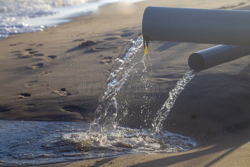Pipe, throwing waste into the sea. Pipe, throwing waste into the sea
