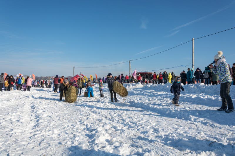 City of Uglich, Yaroslavl region, Russia - 10.02.2018: Merry competition for hay carrying at the festival Winter fun in Uglich 10.02.2018 in Uglich Yaroslavl region Russia. City of Uglich, Yaroslavl region, Russia - 10.02.2018: Merry competition for hay carrying at the festival Winter fun in Uglich 10.02.2018 in Uglich Yaroslavl region Russia.