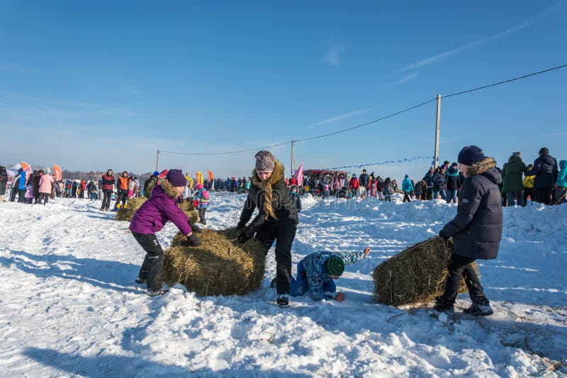 City of Uglich, Yaroslavl region, Russia - 10.02.2018: Merry competition for hay carrying at the festival Winter fun in Uglich 10.02.2018 in Uglich Yaroslavl region Russia. City of Uglich, Yaroslavl region, Russia - 10.02.2018: Merry competition for hay carrying at the festival Winter fun in Uglich 10.02.2018 in Uglich Yaroslavl region Russia.