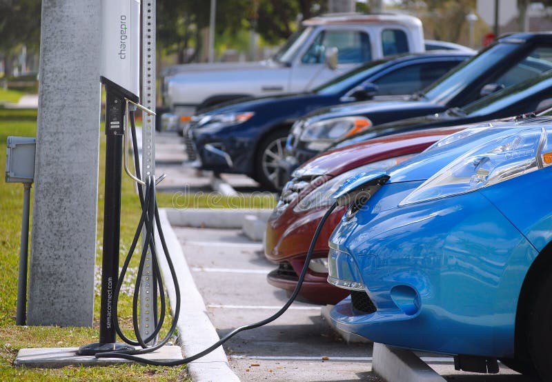 WEST PALM BEACH, FL - February 18, 2018: A blue electric or hybrid car is plugged into a charging station in West Palm Beach, FL.
