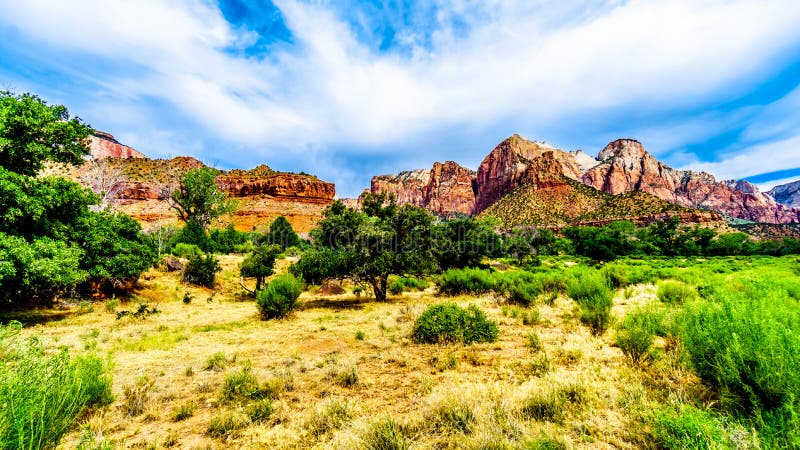 The West Temple, Sundial and Altar of Sacrifice Mountains viewed from the Pa`rus Trail which follows along and over the meandering Virgin River in Zion National Park in Utah, USA. The West Temple, Sundial and Altar of Sacrifice Mountains viewed from the Pa`rus Trail which follows along and over the meandering Virgin River in Zion National Park in Utah, USA