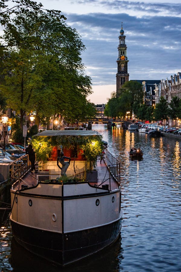 Westerkerk and Houseboat at Sunset in Amsterdam