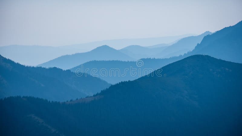 Mountain top panorama in autumn covered in mist or clouds