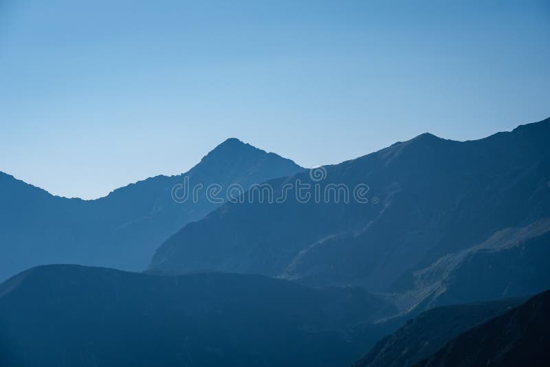 Mountain top panorama in autumn covered in mist or clouds