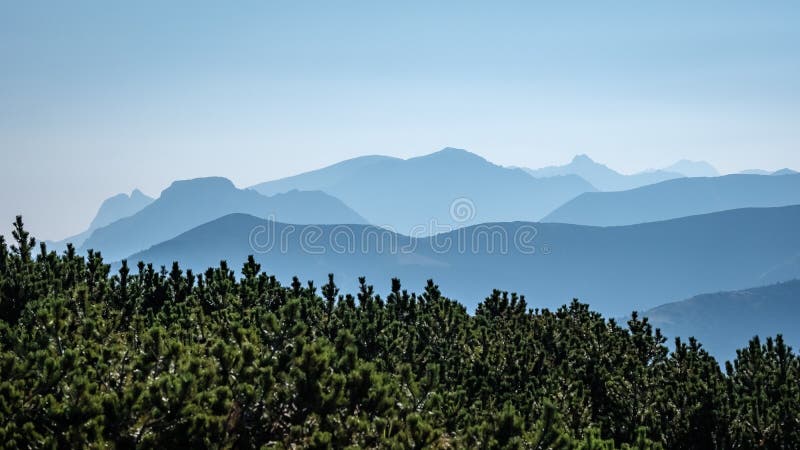 Mountain top panorama in autumn covered in mist or clouds