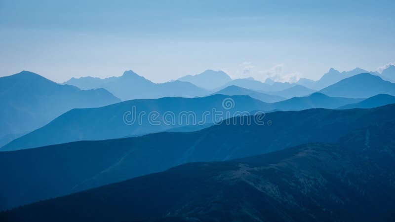 Mountain top panorama in autumn covered in mist or clouds