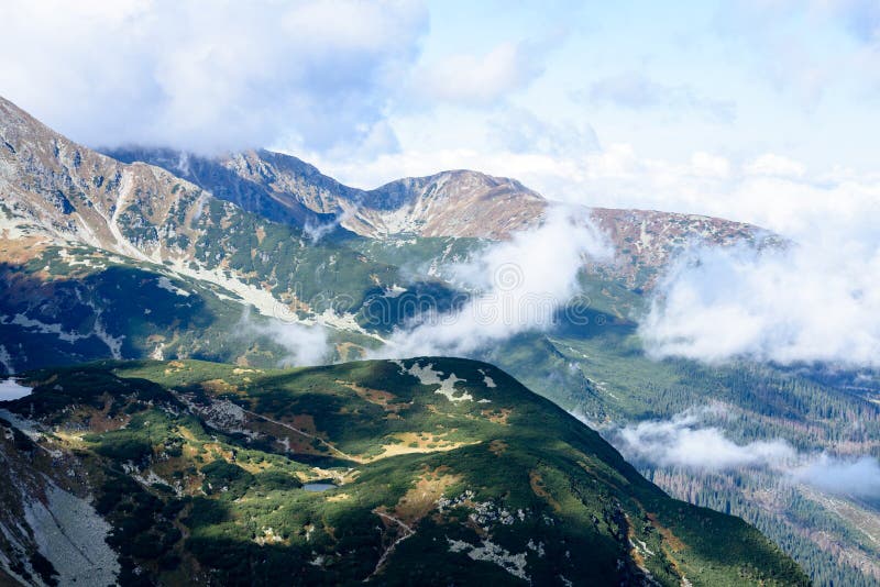 Mountain tops in autumn covered in mist or clouds