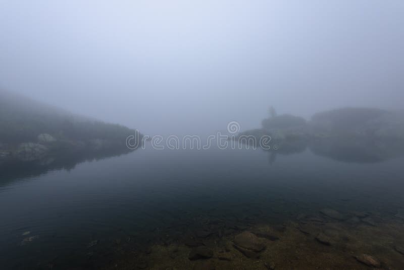 Misty morning view in wet mountain area in slovakian tatra. mountain lake panorama