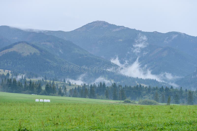 Mountain tops in autumn covered in mist or clouds