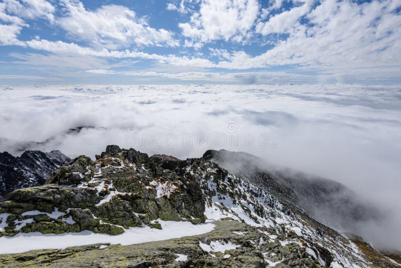 Mountain tops in autumn covered in mist or clouds