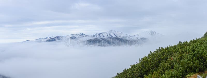 Mountain tops in autumn covered in mist or clouds