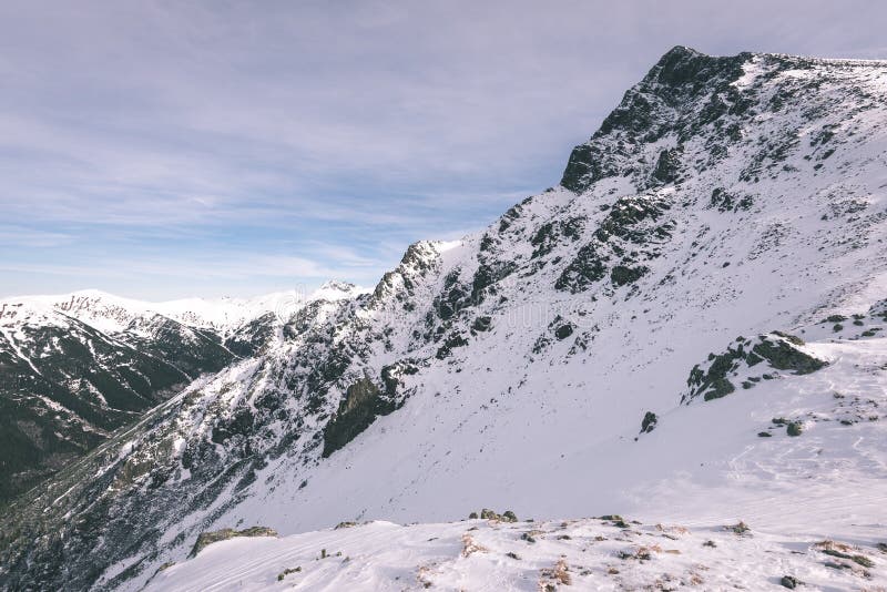 Mountain tops in winter covered in snow - vintage film look