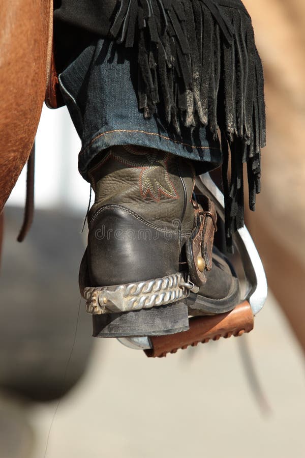 Western riding boots dirty in the neckline in the stirrup royalty free stock photos Western riding boots dirty in the neckline in the stirrup royalty free stock photos