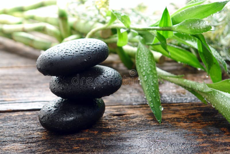 Wet Black Polished Massage Stones Balanced in Spa stock photo Wet Black Polished Massage Stones Balanced in Spa stock photo