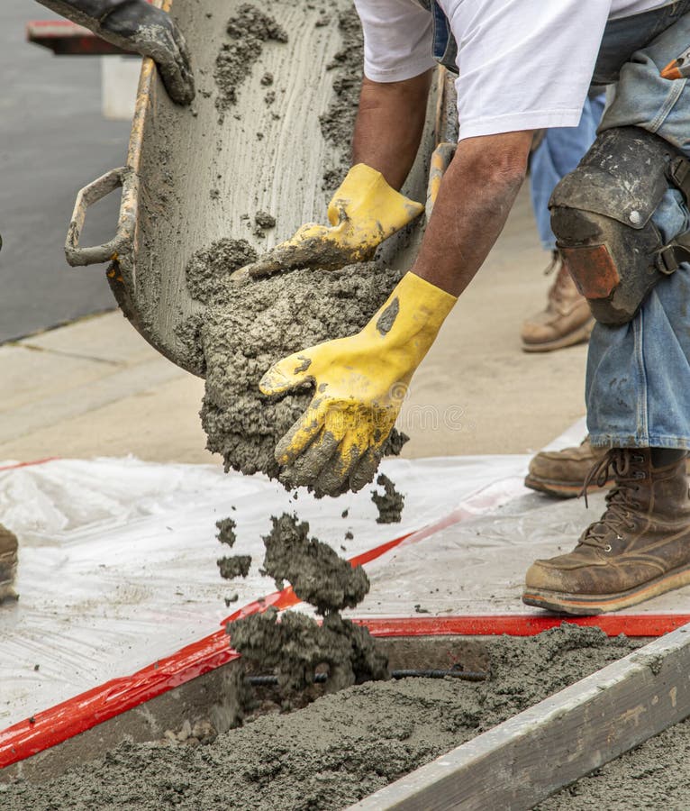 Concrete truck chute pouring wet cement Mix into metal bucket