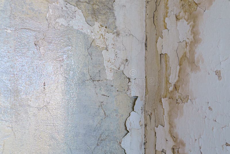 Wet Corner of a Wall with Plaster with Cracks and Dampness Stock Photo