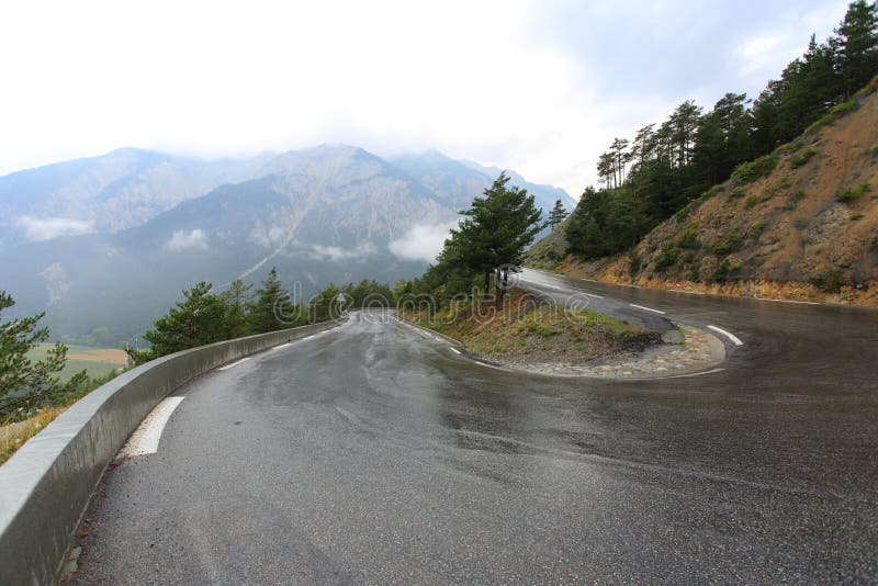 Wet road bend in a rainy day