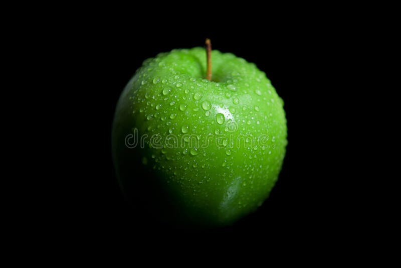 Wet green granny smith apple with black background