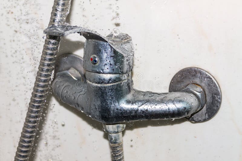 A wet faucet in the shower, water flows from the shower royalty free stock images A wet faucet in the shower, water flows from the shower royalty free stock images